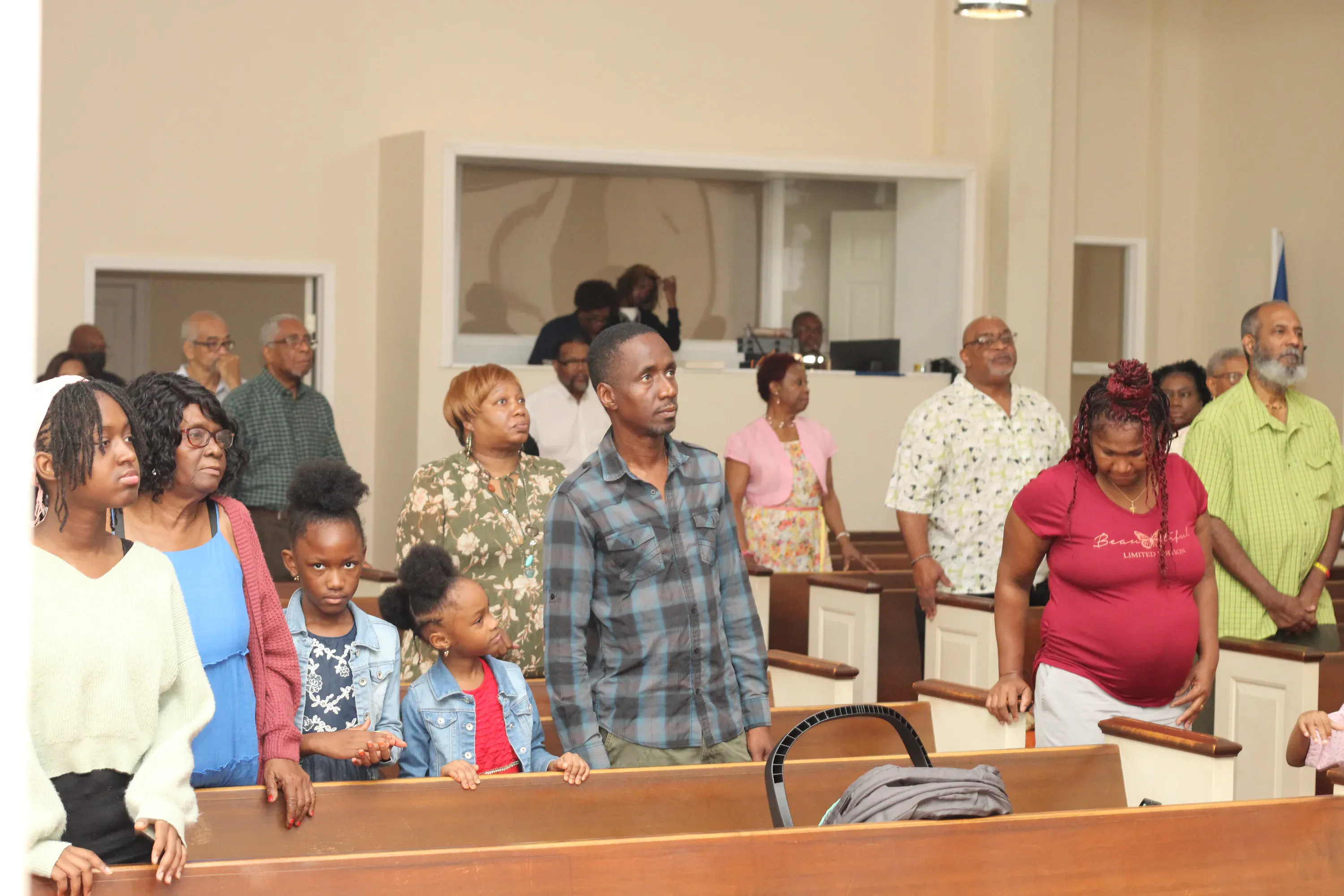Members standing together in the sanctuary during a Sunday service