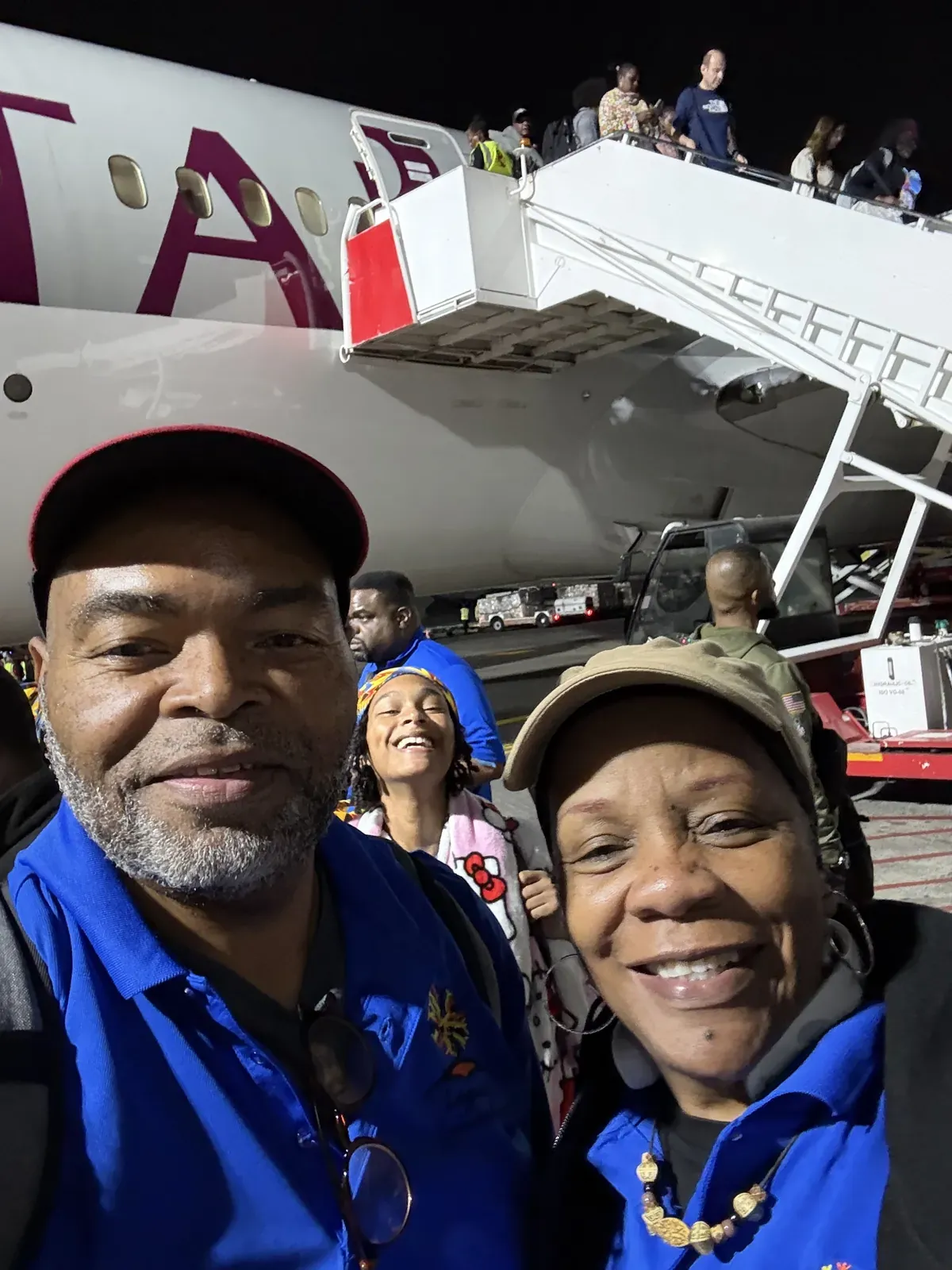 Two of the team photographed at the aircraft steps as they board for Kenya