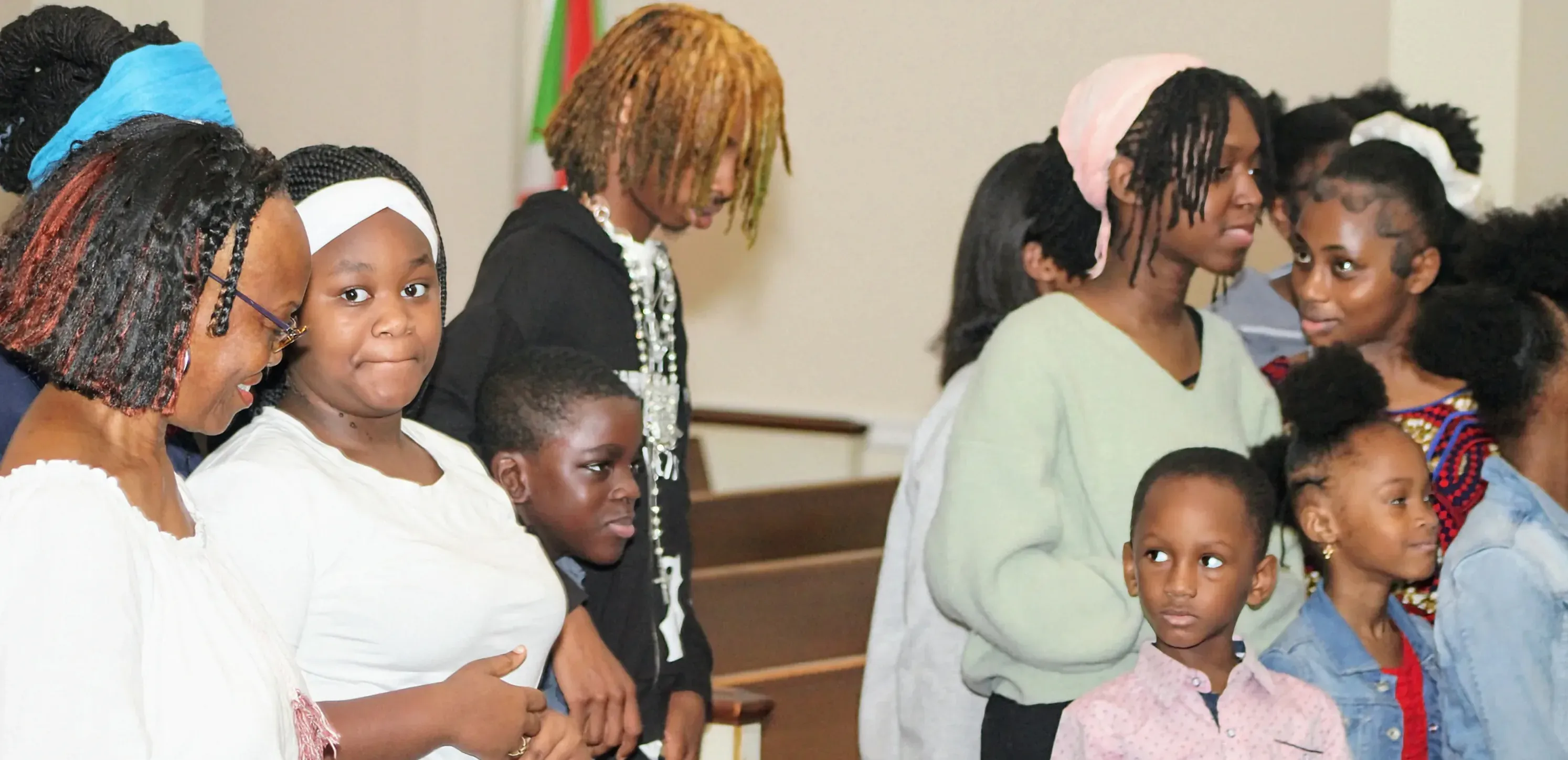 Children and teenagers standing together in the sanctuary