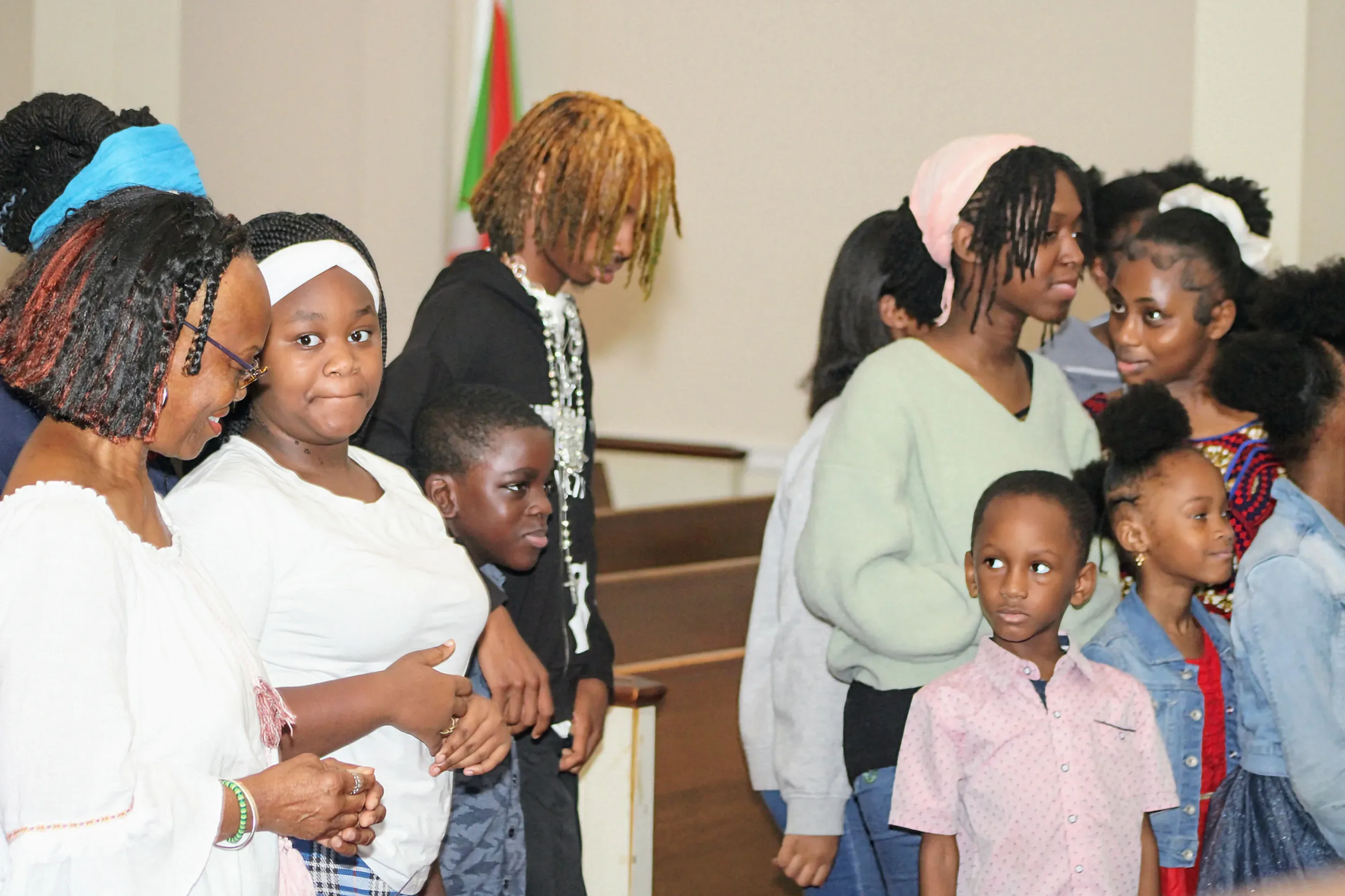 Children and teenagers standing together in the sanctuary