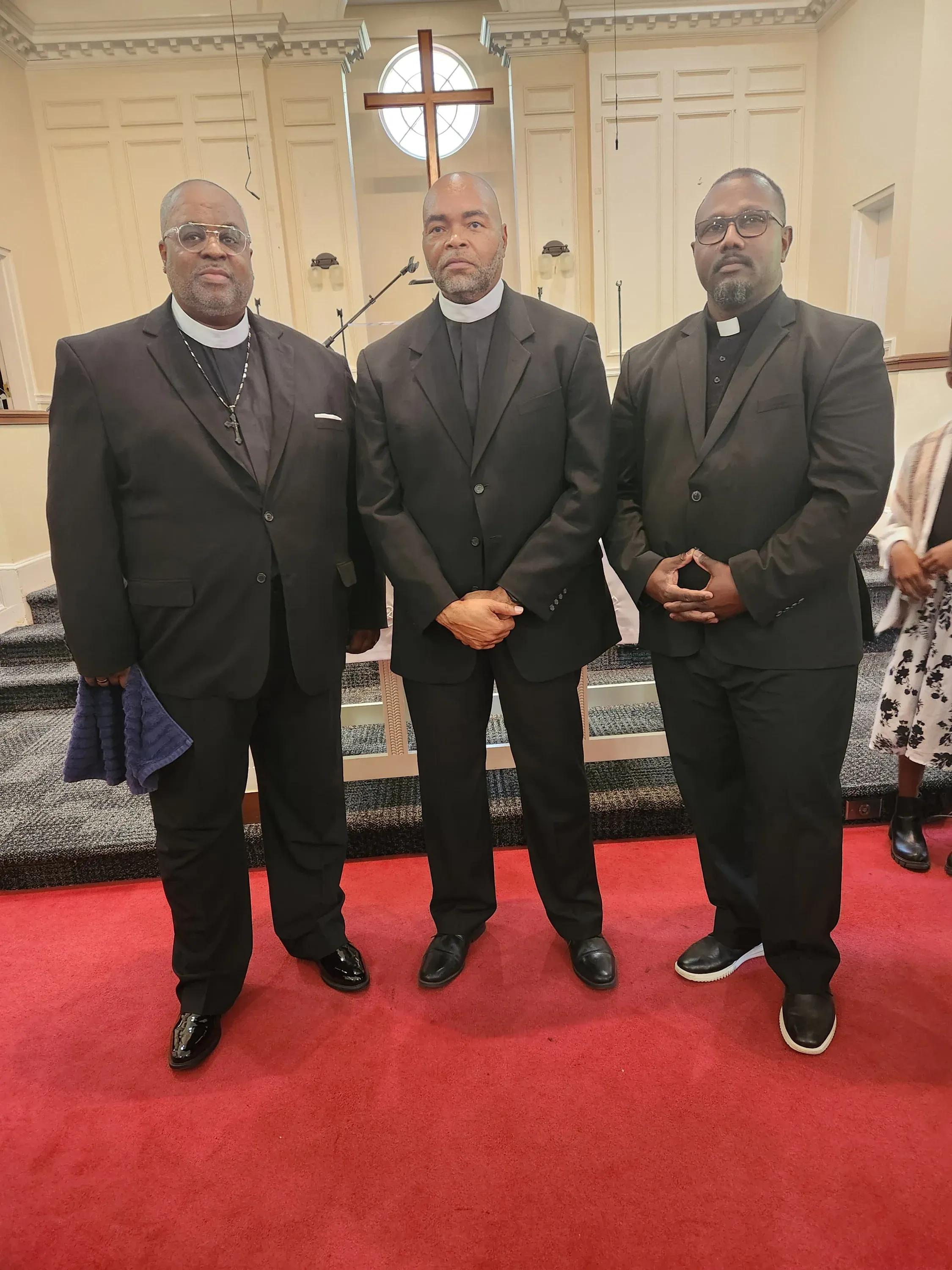 Pastors of White Oak Hills Baptist Church standing before the sanctuary cross