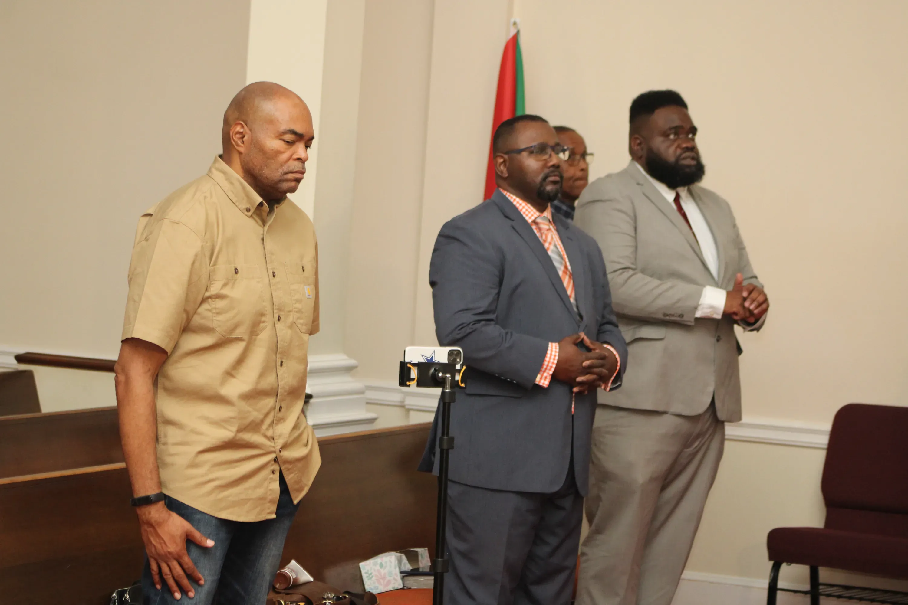 Members standing together during a Sunday service